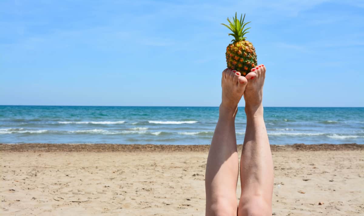 Feet Holding Up Pineapple